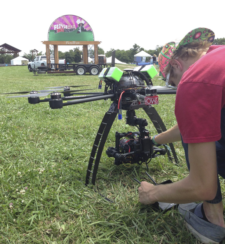 nowsay zach preparing camera on skyjib drone before takeoff